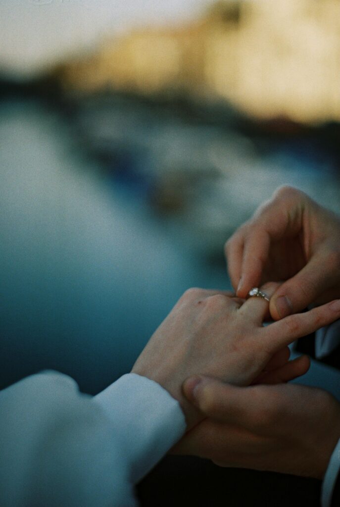Romantic moment of a marriage proposal with ring exchange, showcasing love and commitment.